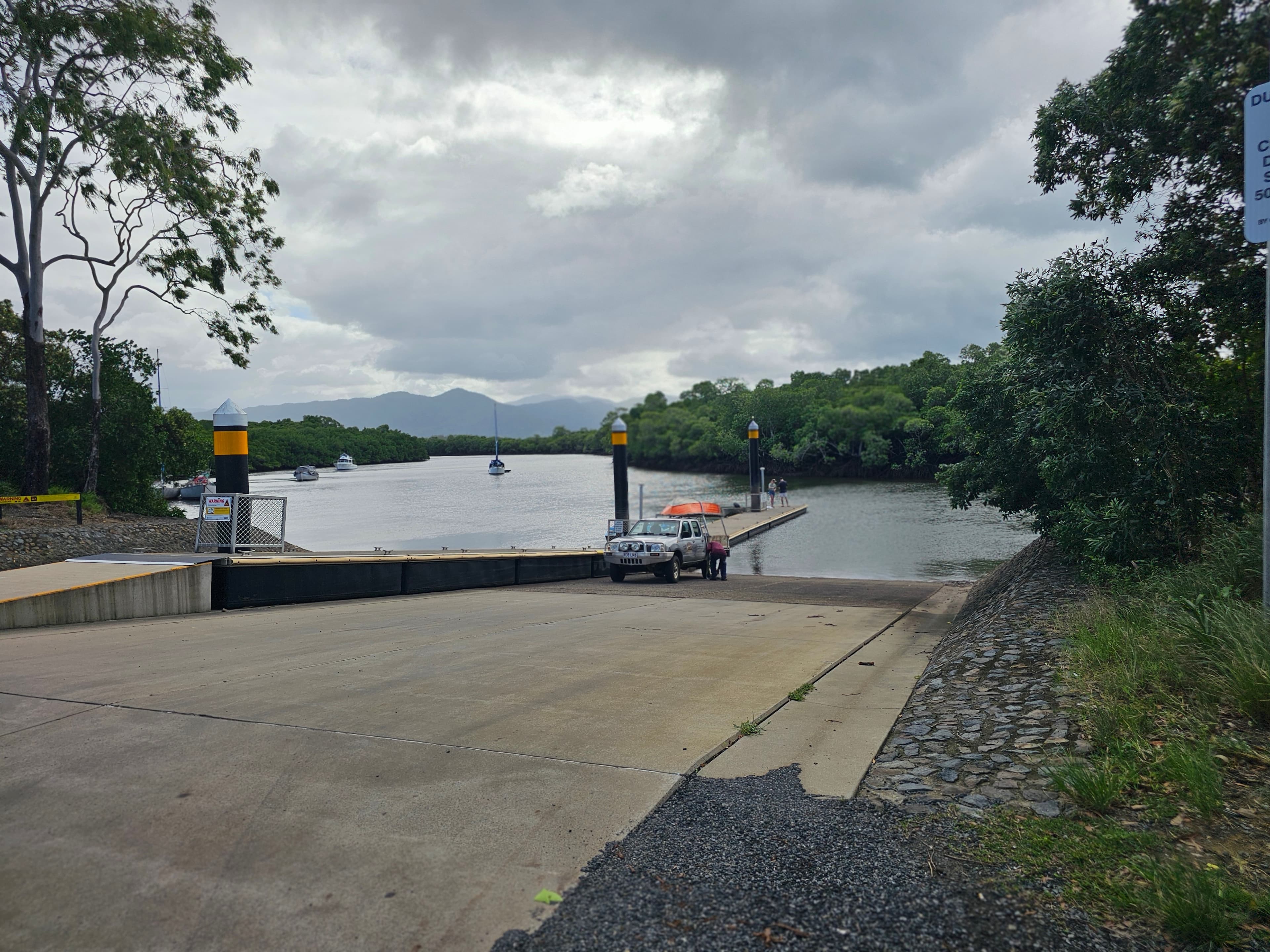 A four-wheel drive reversing a trailer down the all-tide concrete boat ramp